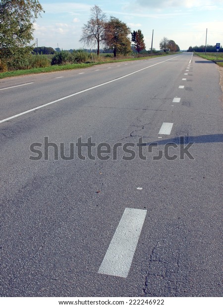 Asphalt road\
with marker lines in rural\
district