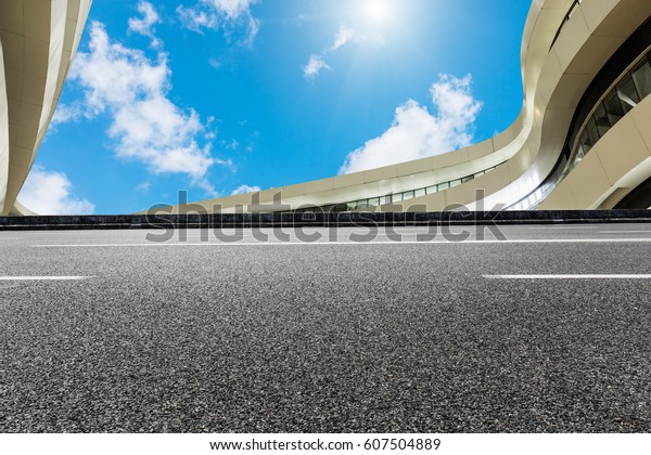 Asphalt road and\
modern building\
landscape