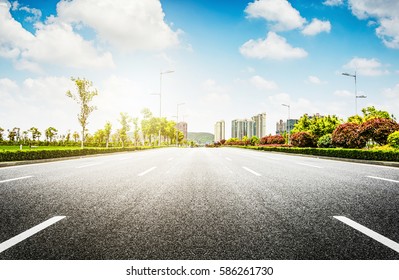 Asphalt road and modern city - Shutterstock ID 586261730