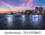 Asphalt road and modern city buildings scenery at night. car advertising background.