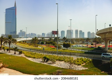 Asphalt road with modern city skyline of Dubai.