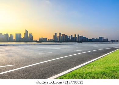 Asphalt road and modern city skyline with buildings in Hangzhou at sunset, China. - Powered by Shutterstock