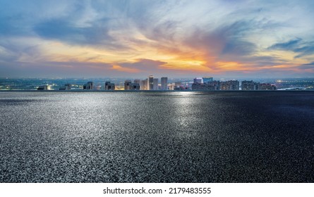 Asphalt road and modern city skyline with building scenery at night. high angle view. - Powered by Shutterstock