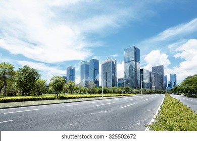 asphalt road of a modern city with skyscrapers as background
