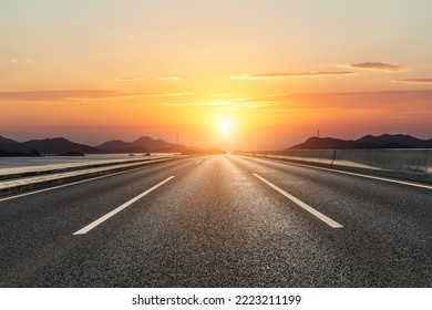 Asphalt road and mountain with beautiful sky clouds at sunset