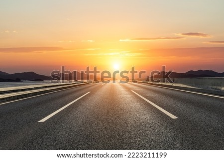 Asphalt road and mountain with beautiful sky clouds at sunset