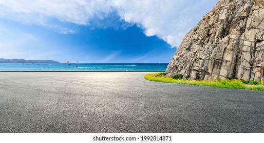 Asphalt road and mountain with blue sea natural landscape.