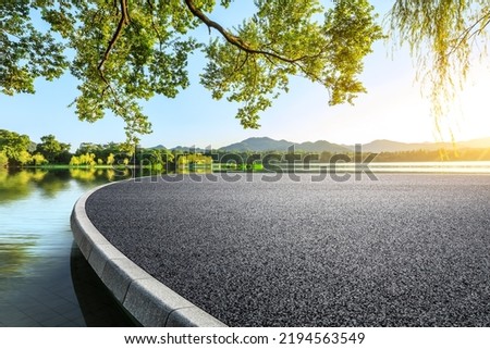 Asphalt road and mountain with lake natural scenery in Hangzhou, China.