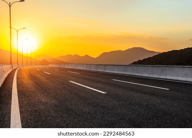Asphalt road and mountain natural background at sunset