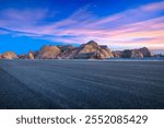 Asphalt road and mountain natural landscape at dusk in Xinjiang. Outdoor natural background.