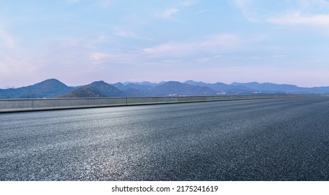 Asphalt road and mountain natural scenery at dusk - Shutterstock ID 2175241619