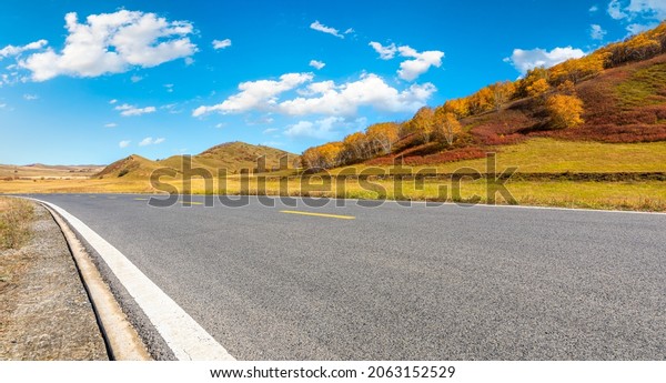 Asphalt\
road and mountain nature landscape at\
autumn.