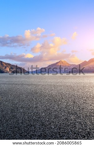 Asphalt road and mountain scenery at sunrise. Highway and mountain background.