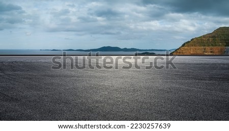 Asphalt road and mountain with sea natural landscape on a cloudy day