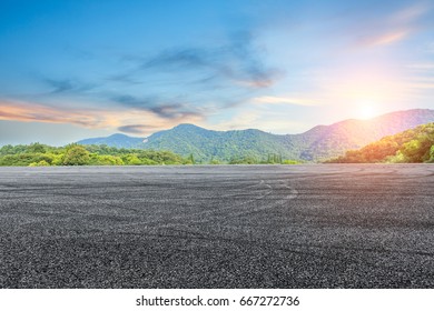 asphalt road and mountain at sunset - Shutterstock ID 667272736