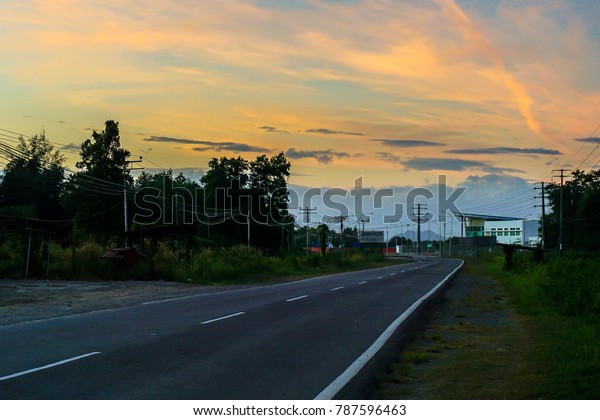 Asphalt road on\
golden sky in morning day at sunrise scene with an empty &\
silent road.Copy\
space.Conceptual.
