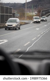 Asphalt Road With Oncoming Car Seen From A Moving Car.