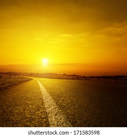 Asphalt Road And Orange Sunset