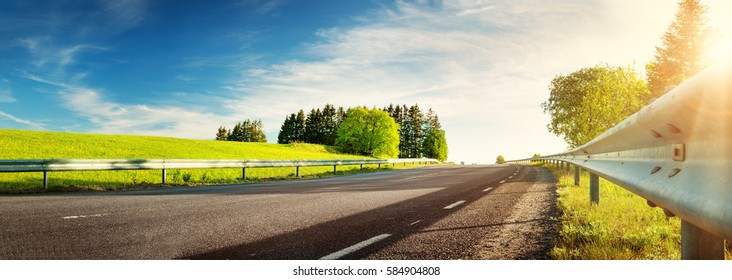 asphalt road panorama in countryside on sunny spring evening - Powered by Shutterstock