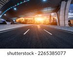 Asphalt road and pedestrian bridge with modern city skyline at sunset in Ningbo, Zhejiang Province, China.