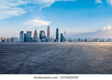Asphalt road platform and city skyline with modern buildings in Guangzhou, Guangdong Province, China.