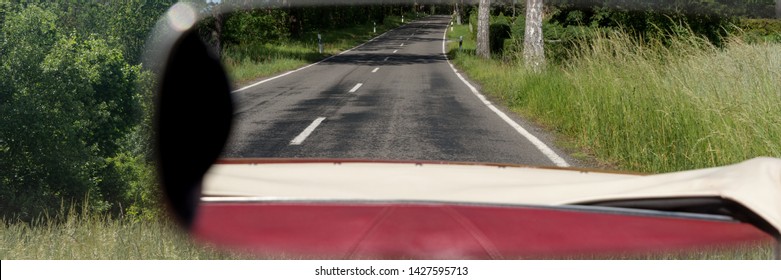 Asphalt Road In The Rearview Mirror. Rear View Mirror In The Cabriolet