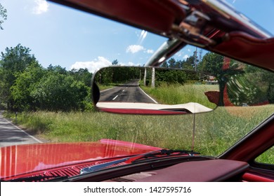 Asphalt Road In The Rearview Mirror. Rear View Mirror In The Cabriolet