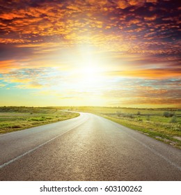 Asphalt Road To Red Horizon In Sunset