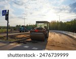 Asphalt road roller on New road construction. Vibration roller compactor on press new asphalt on roadway. Road Construction Equipment on construction site. Vibration roller at asphalt pavement.
