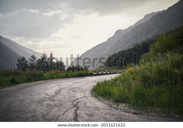Asphalt road serpentine in the\
mountains in Kazakhstan. Famous mountain road to Big Almaty\
Lake.