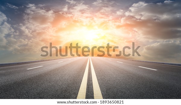 Asphalt\
road and sky clouds at sunset.Road\
background.