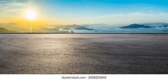 Asphalt road square and beautiful coastline with mountain natural landscape at sunset. High Angle view. - Powered by Shutterstock