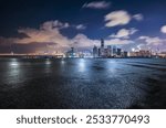 Asphalt road square and city skyline with modern buildings scenery at night in Shenzhen. car advertising background.