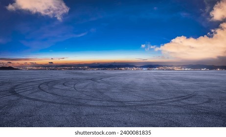 Asphalt road square and city skyline at night. High Angle view. - Powered by Shutterstock