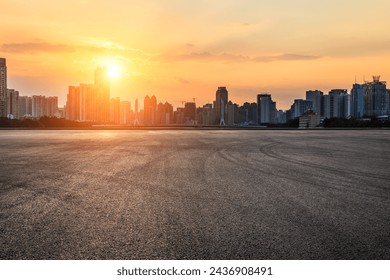 Asphalt road square and city skyline with modern buildings scenery at sunset - Powered by Shutterstock