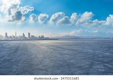 Asphalt road square and city skyline with modern buildings scenery under the blue sky