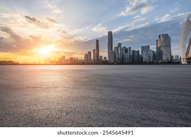 Asphalt road square and city skyline with modern buildings scenery at sunset in Guangzhou. car advertising background.