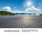 Asphalt road square and clear lake with green mountain nature landscape under blue sky. Car background.