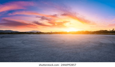 Asphalt road square and colorful sky clouds at sunset