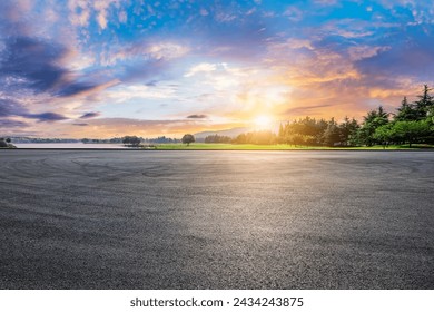 Asphalt road square and green forest natural landscape at sunset - Powered by Shutterstock