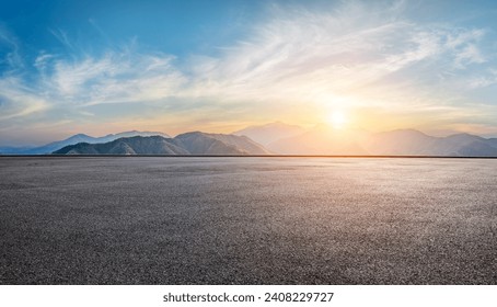 Asphalt road square and green mountain with sky clouds at sunset. High Angle view. - Powered by Shutterstock