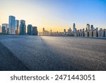 Asphalt road square and modern city buildings at sunrise 