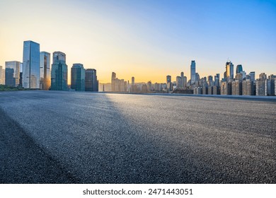 Asphalt road square and modern city buildings at sunrise  - Powered by Shutterstock