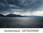 Asphalt road square and mountain with black rain clouds natural landscape before the rainstorm