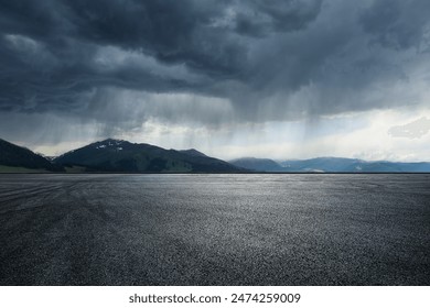 Asphalt road square and mountain with black rain clouds natural landscape before the rainstorm - Powered by Shutterstock