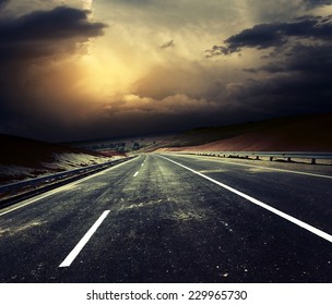 Asphalt Road And Stormy Sky