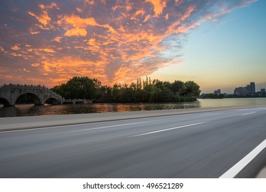 Asphalt Road With Sunset And Beautiful Cloud,Car Ad. Background