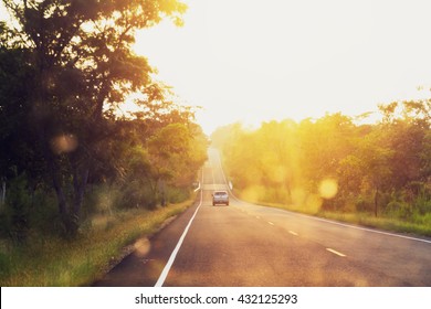  Asphalt Road At Sunset With Blur Car