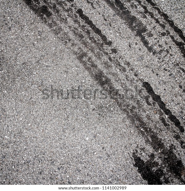 asphalt road texture with dark tire tracks on gray\
asphalt road