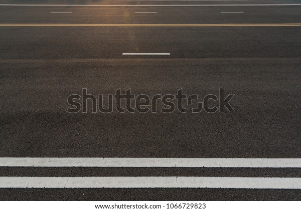 Asphalt road\
texture with white stripe, Road way background texture and Traffic\
sign. Traffic lines on the\
street.